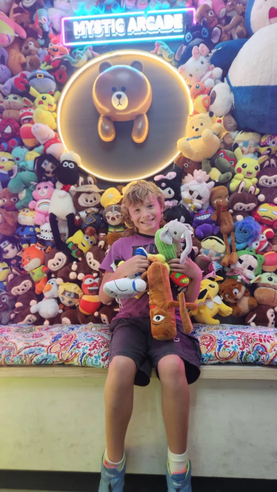 Young winner with a claw machine prize