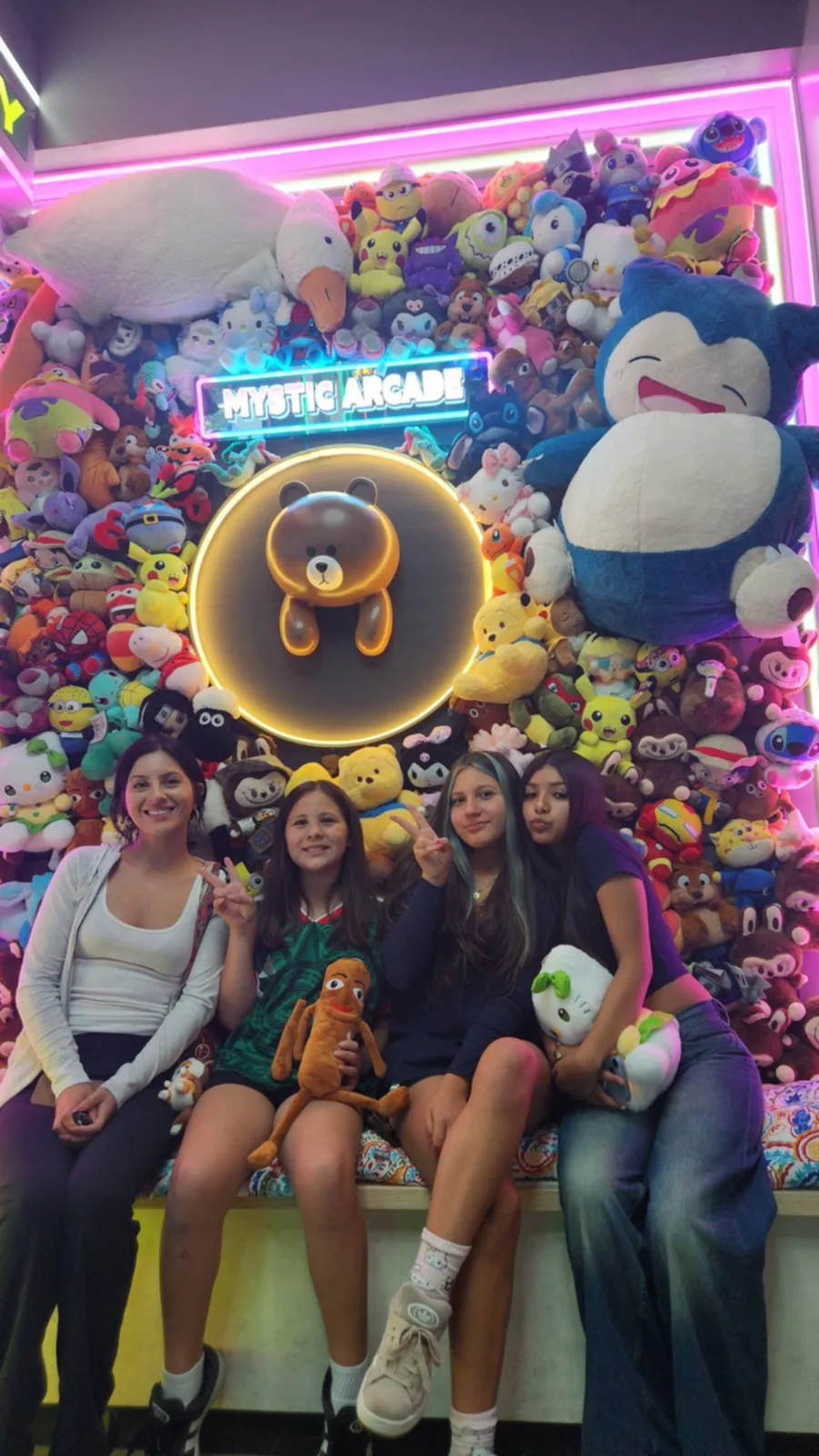 Group seated at the plush wall photo op