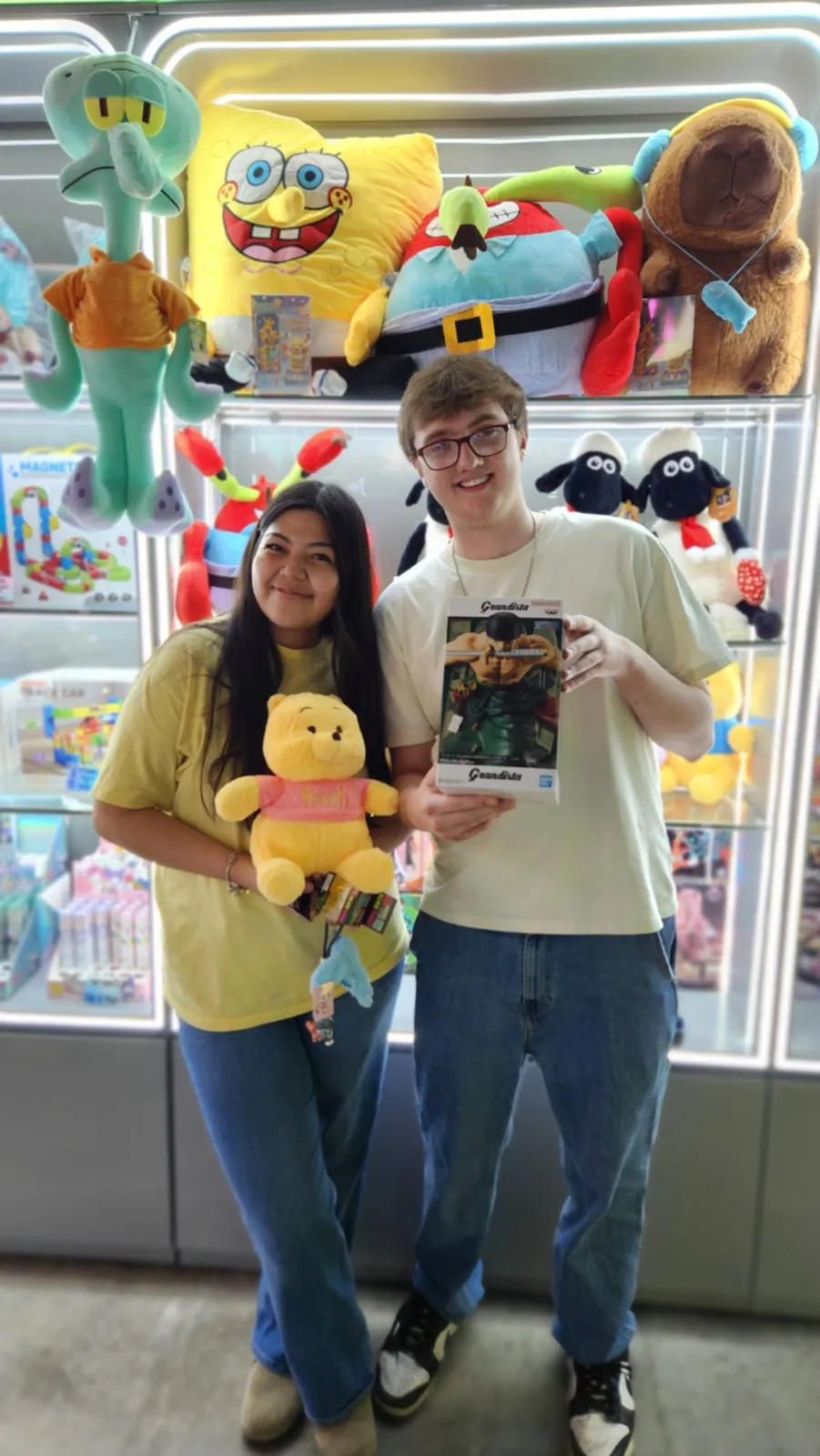Couple with plush and poster wins