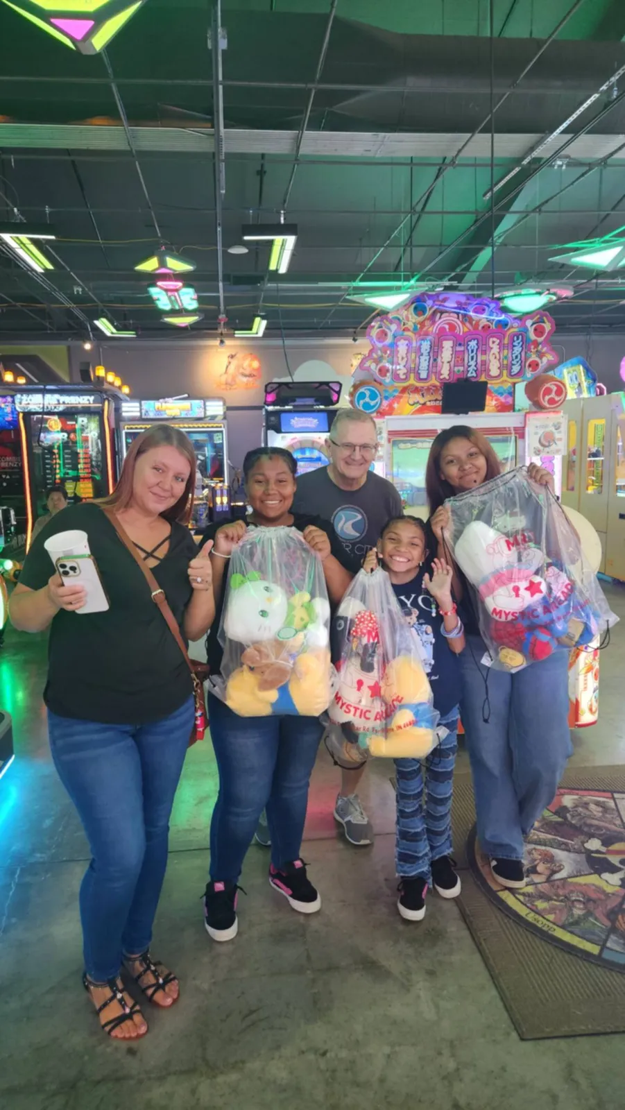 Family with plushes on the arcade floor