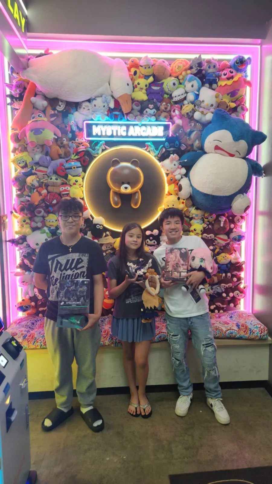 Friends posing at the plush wall